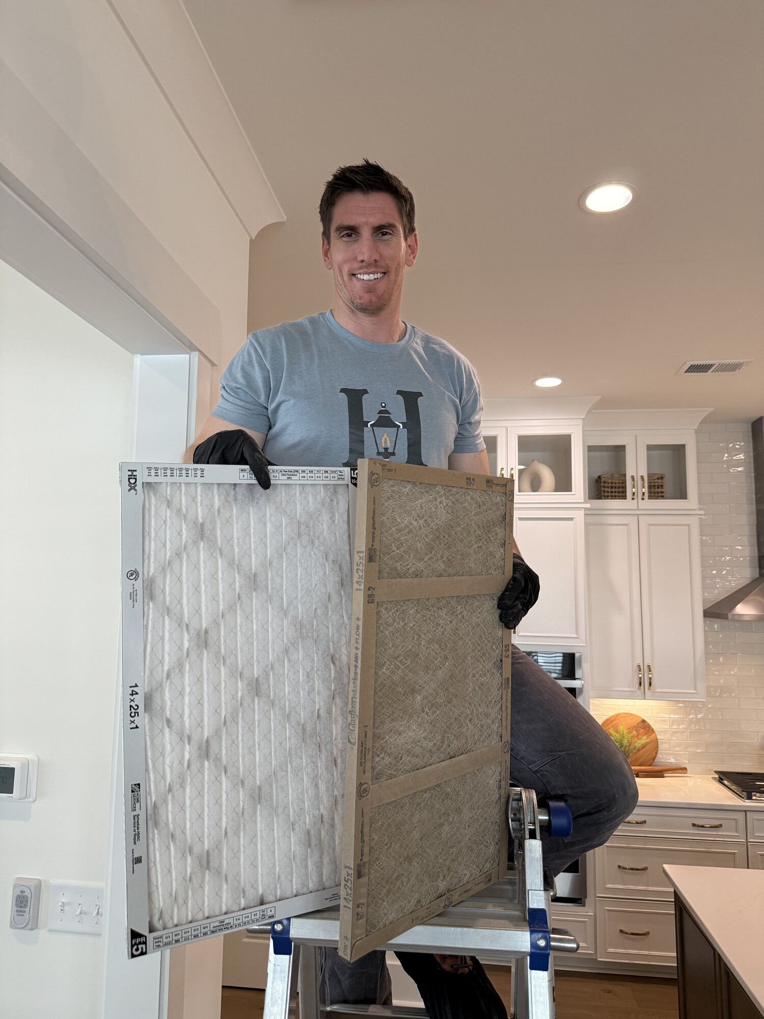 Haven team member swapping out a dirty HVAC filter for a new one during a quarterly home maintenance visit